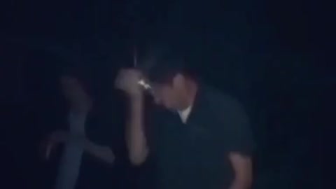 Guy in dark shirt cracks beer on head it sprays everywhere