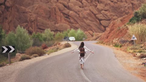 Woman Walking In The Middle Of The Road