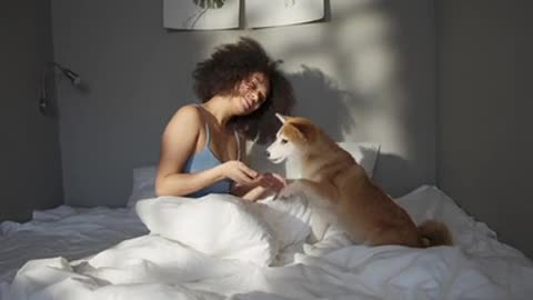 A cute girl plays and feeds a small cute dog 😍