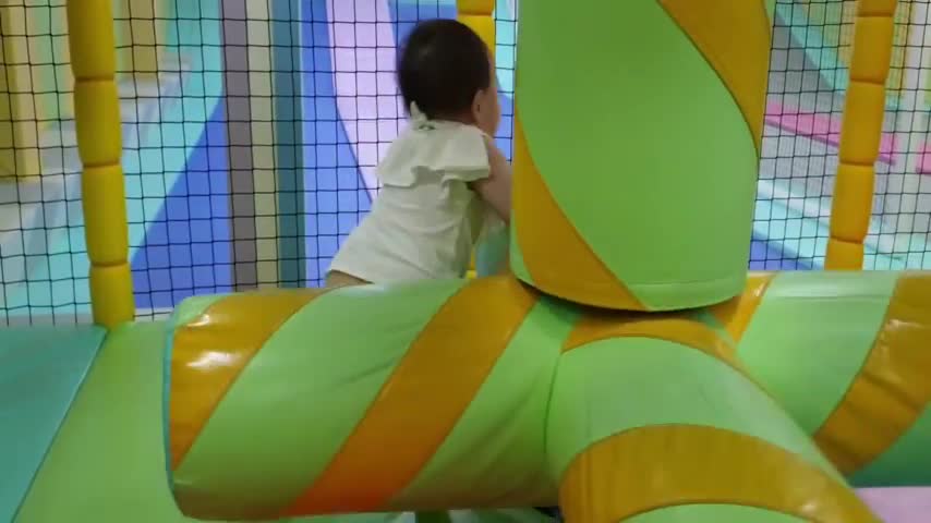 It is a baby who is playing with excitement while spinning round and round.