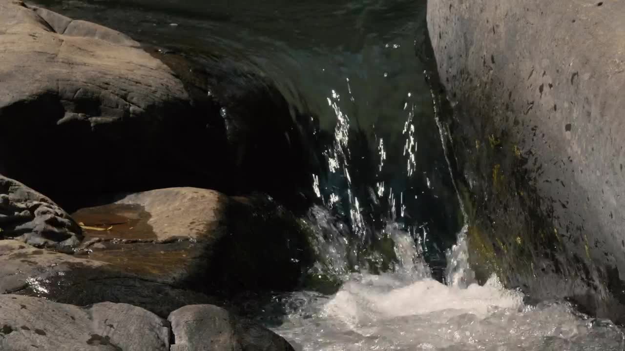 Water falls between rocks