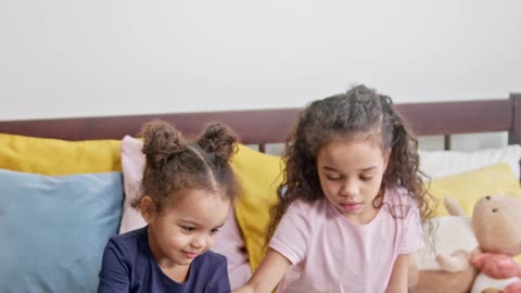 Children and cat best friends playing in bed