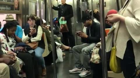 Guy in black dress shirt standing subway gold string being sucked into air conditioning vent