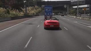 Toddler Stands Up in Back of Convertible