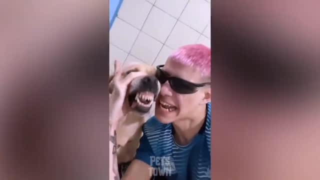 How is this man singing a laughing song along with the dog?