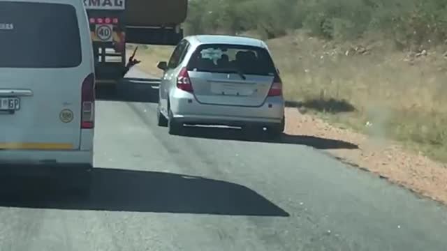 Car Attempts to Pass Truck on Narrow Road