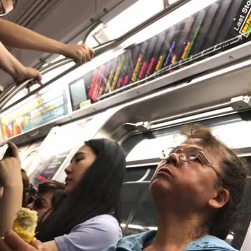 Woman in blue eating corn on the cob