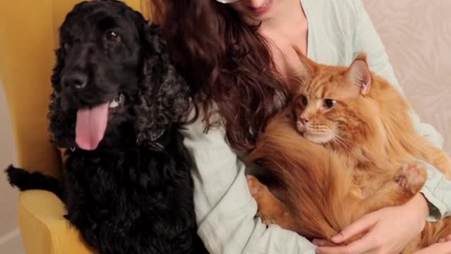 A woman holding a cat