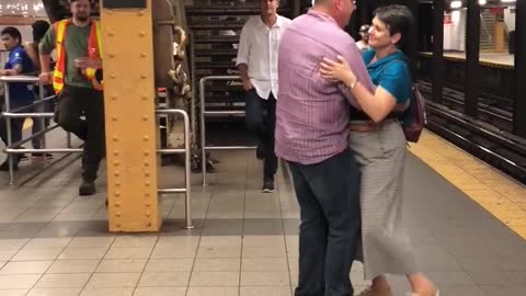 Man in blue flannel playing jazz music couple dances