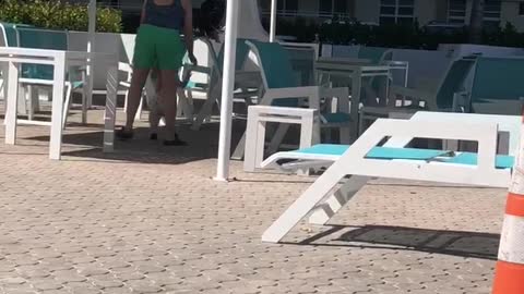 Mila walking around the pool