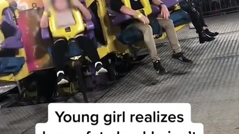 Young girl realizes her safety buckle isn't latched on fair ride