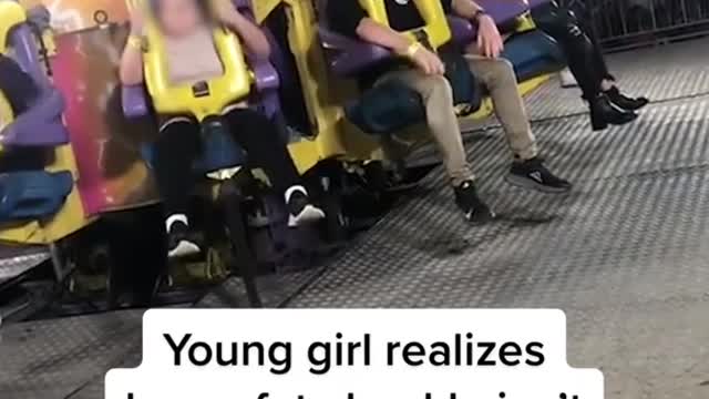 Young girl realizes her safety buckle isn't latched on fair ride