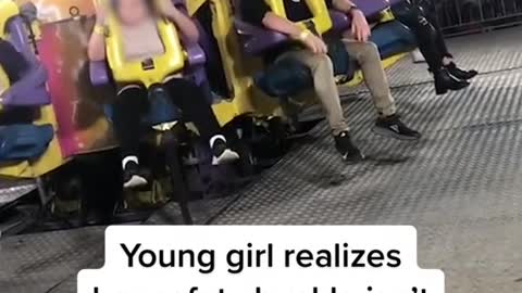 Young girl realizes her safety buckle isn't latched on fair ride