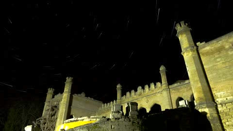 Star trails over a castle