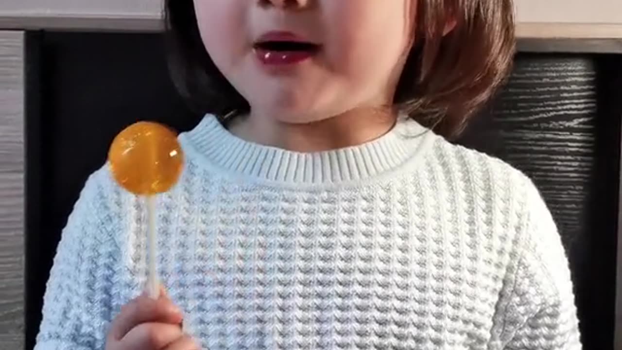 Super cute baby eating lollipops