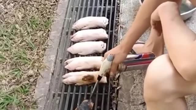 Man cooks pork trotters over longkang grille in MacPherson