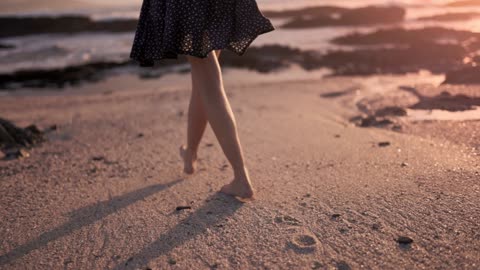 Woman Walking Barefooted On The Shore