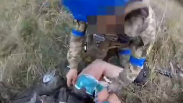 French NATO soldiers administer First Aid to a wounded Russian soldier