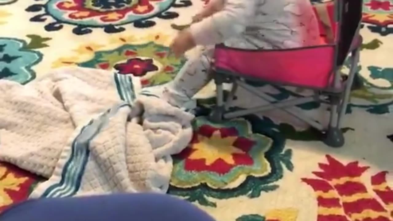 Toddler tries to sit in a chair. Funny!