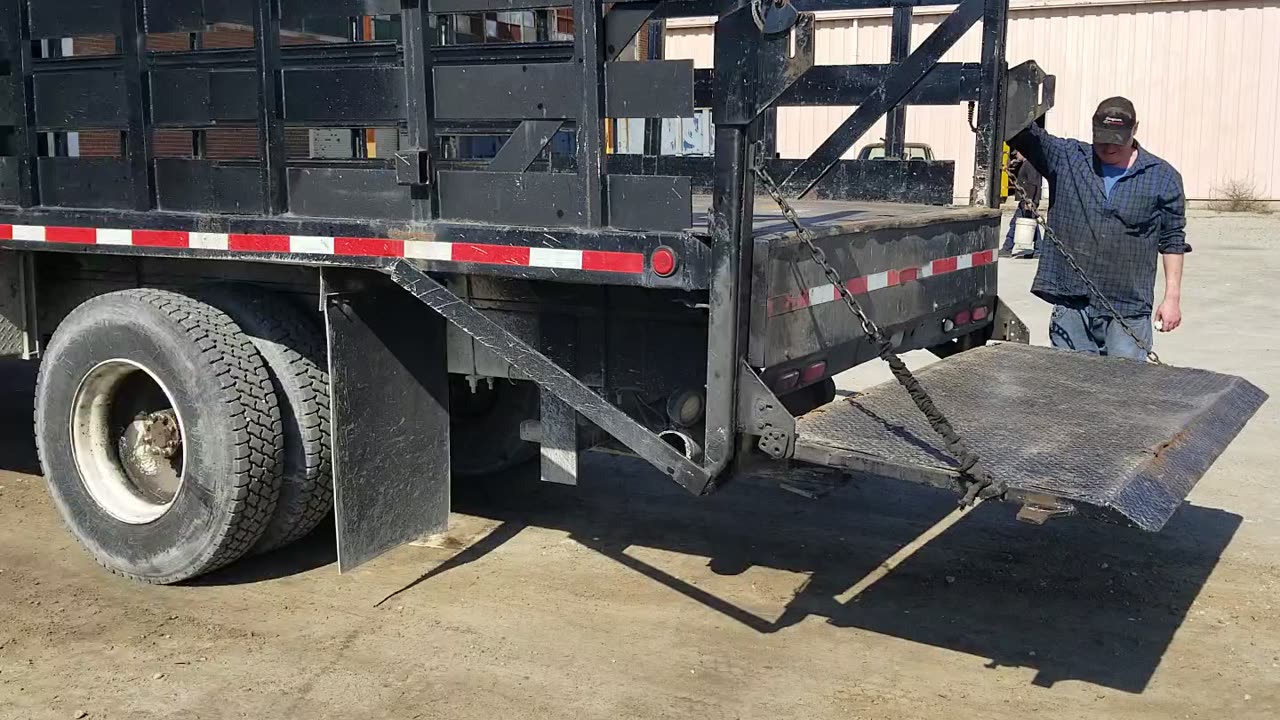#1265 1998 International 4700 with a 21 foot stake bed.