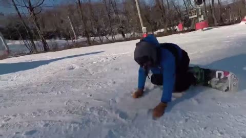 Snowboarder Rolling Over A Huge Tire In The Snow