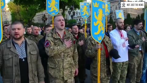 UKRAINE Soldiers march with swastika pendants adorning their uniforms in a..