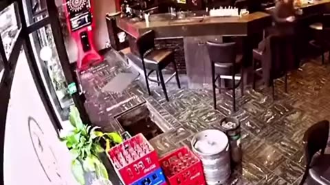 Woman falls down a hole while entering a cafe