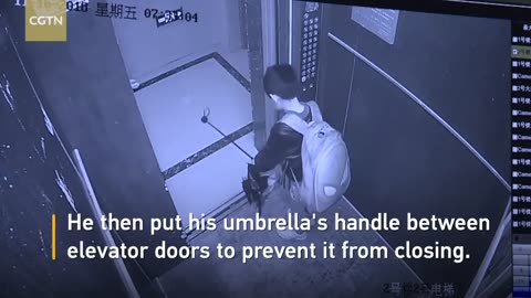 Boy uses umbrella to prevent elevator door from closing, causes free fall