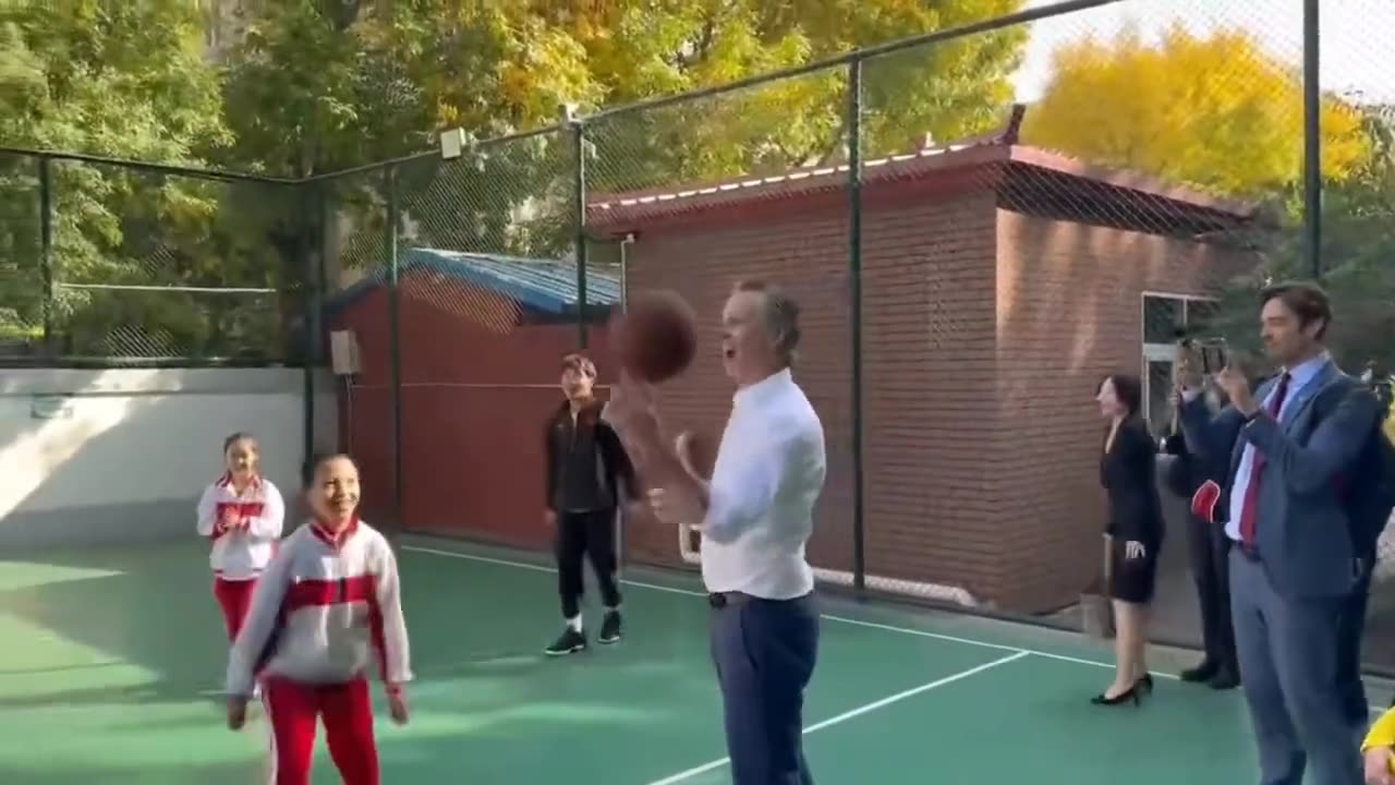 Gavin Newsom runs over a small Chinese child while playing basketball during his visit to China