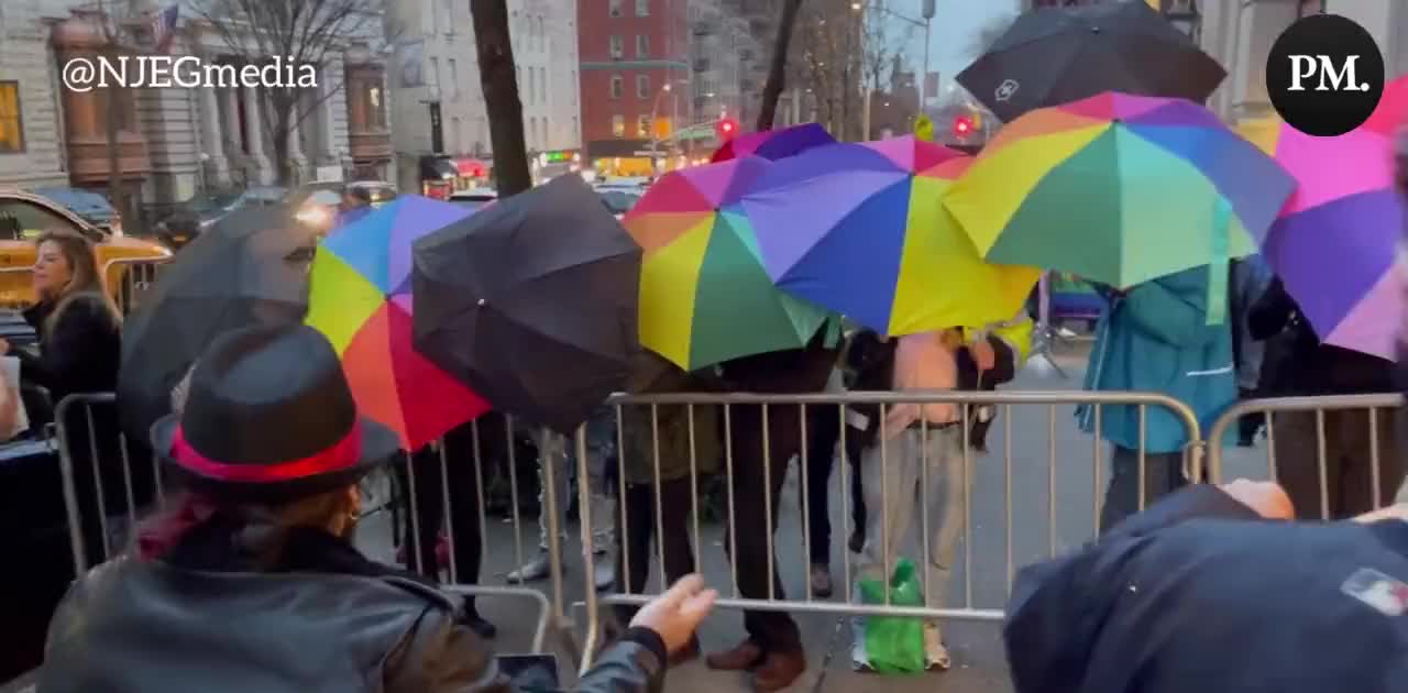 Counter-protesters at a Drag Queen Story Hour event in New York sing "Twinkle Twinkle Little Star" to protesters while holding rainbow umbrellas