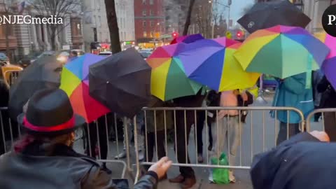 Counter-protesters at a Drag Queen Story Hour event in New York sing "Twinkle Twinkle Little Star" to protesters while holding rainbow umbrellas