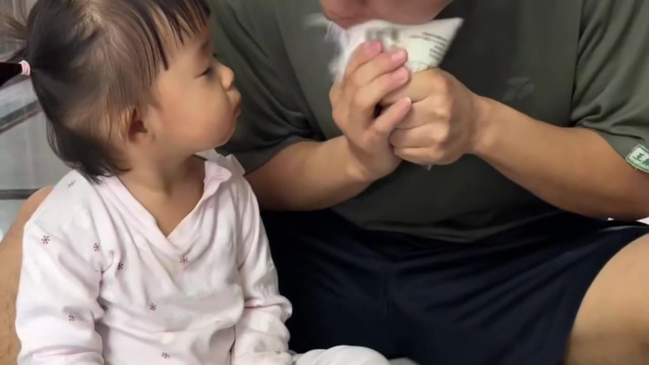 Dad accidentally sprays milk on daughter's face