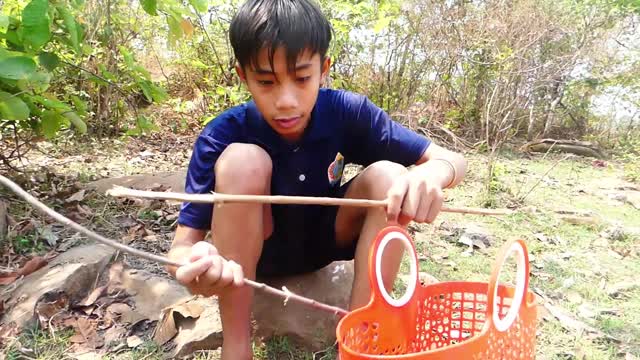 survival in rainforest smart boy Fishing and catch fish Cook Eating delicious in forest river