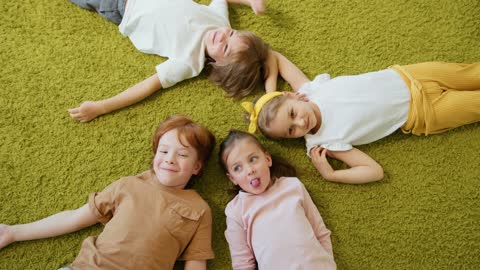 Cute Children Lying Down on the Floor