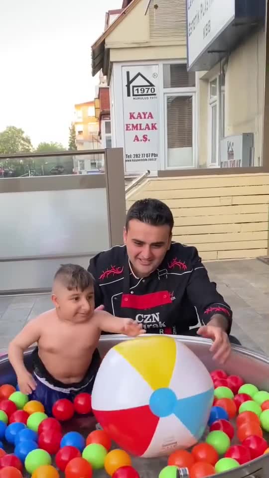 small man exciting to swim in a big cooking pot pool.mp4