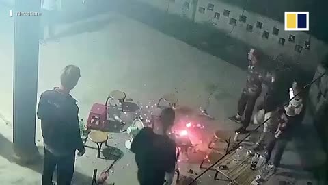 Fire pit suddenly explodes as family gathers around in China