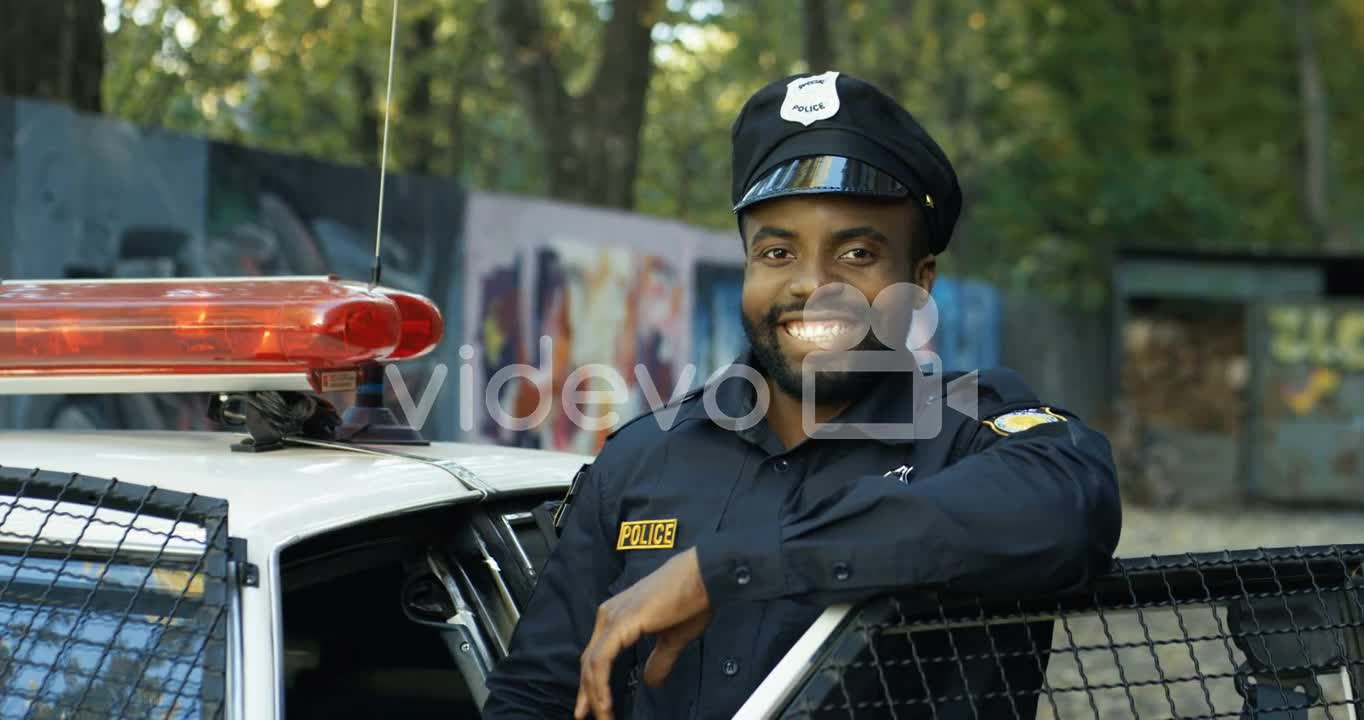 Portrait Of Handsome Young Policeman In Uniform And Cap 1