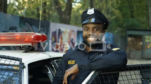 Portrait Of Handsome Young Policeman In Uniform And Cap 1