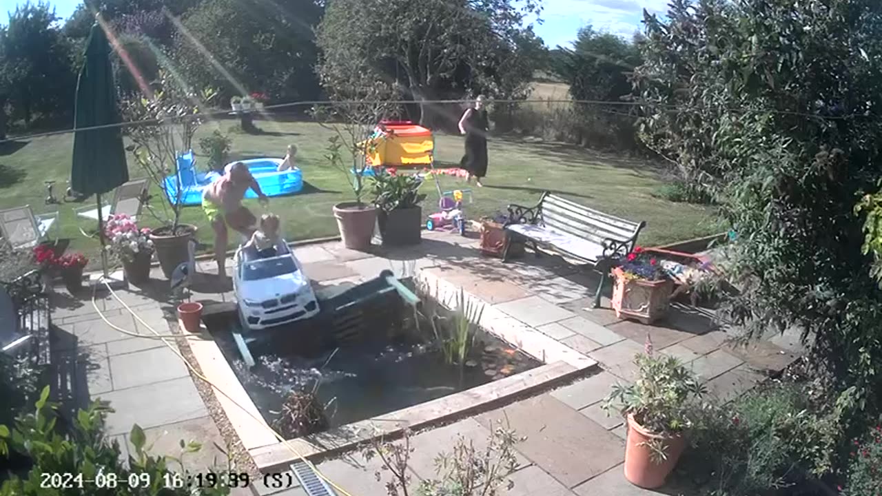 Boy Drives Toy Car Into Backyard Pond