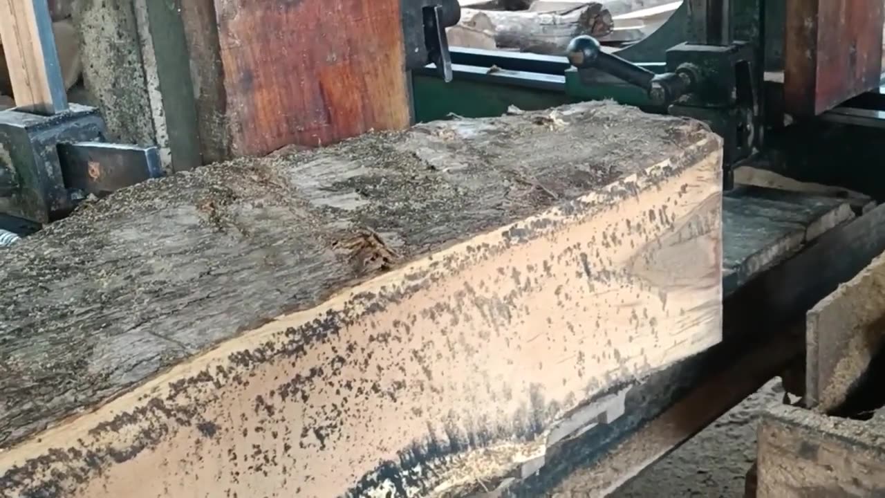 sawing wood almost rotten board beam material in the rafting machine