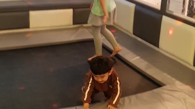 Enjoying playing the Stampoline at a kids cafe.