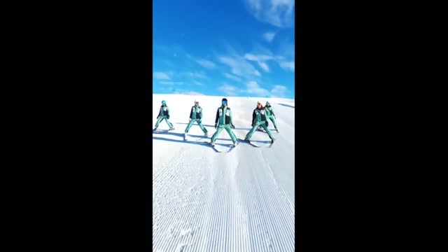 skiers dancing in perfect sync in the snow