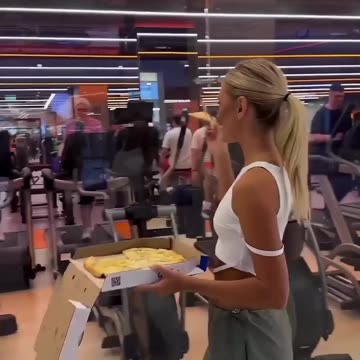 would you like to eat this ? girl outside gym, tempting with delicious food.