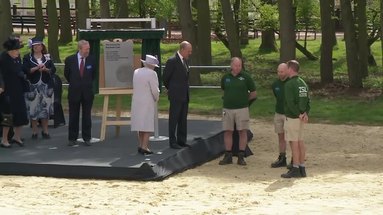 Queen and Duke of Edinburgh feed elephants bananas