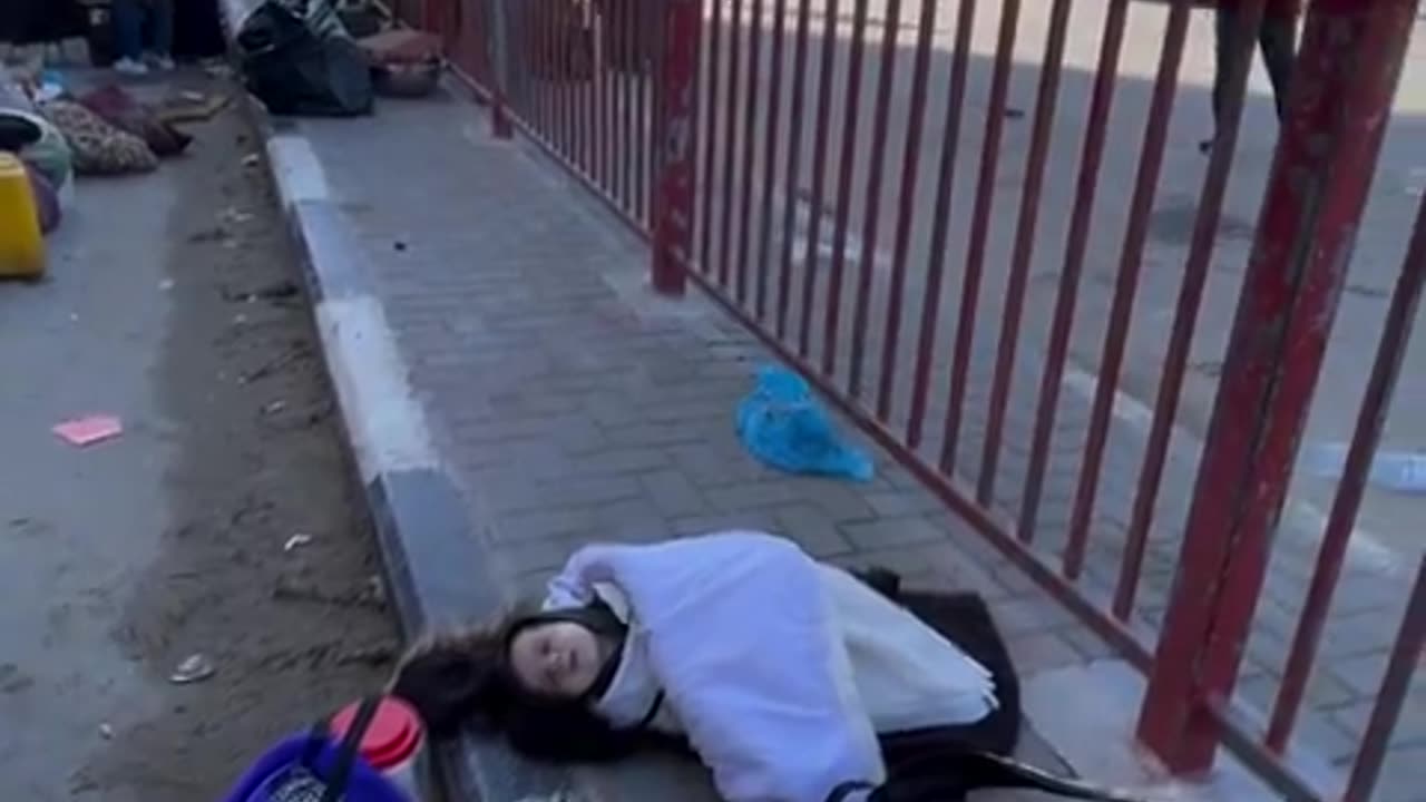 A little Gazan boy sleeps on the pavement in winter cold