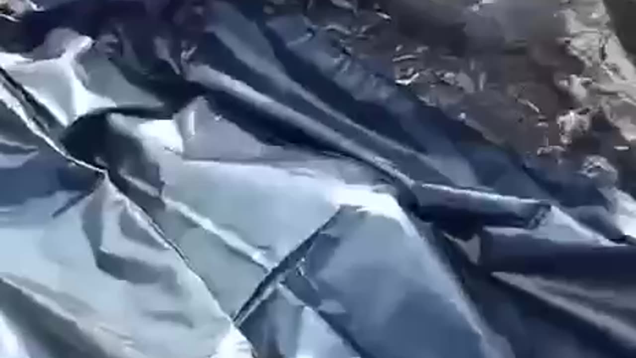 Russian Soldier Sifting Through Burned Vehicles for Friends