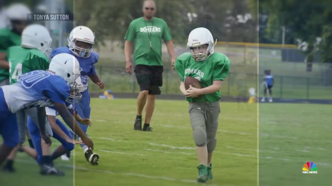 Elementary school football teams come together to set up special play for teammate