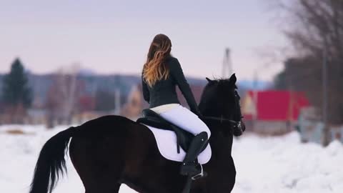 Winter time. A woman with red lipstick riding a horse in a village