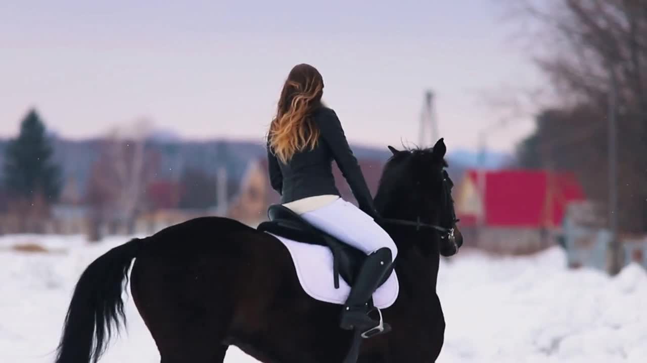Winter time. A woman with red lipstick riding a horse in a village