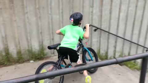 Kid yells 'call 911!' as he falls off his bike.